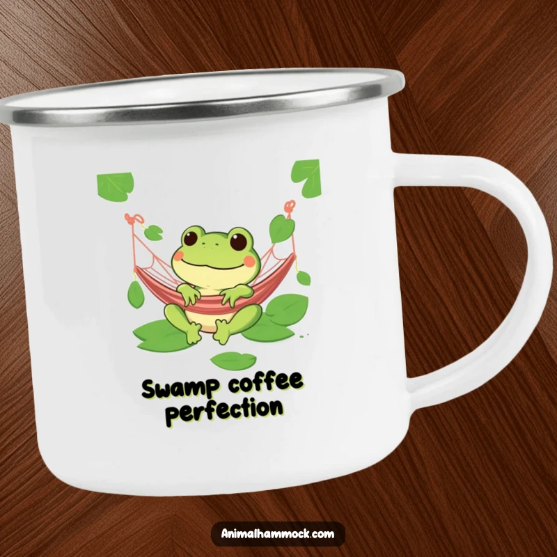Funny green frog grinning in a hammock on a sturdy camping mug, ready for outdoor relaxation.