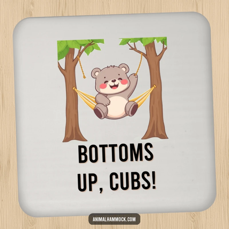 Funny chubby bear cub gleefully dangling from a hammock strung between two trees, printed on these coasters.