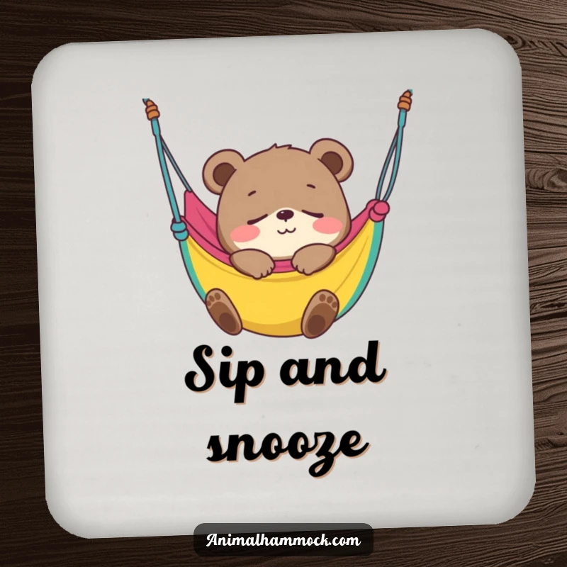 Funny Bear Cub Coaster depicting a smiling cub blissfully fast asleep in a colorful hammock, protecting surfaces with a humorous touch.
