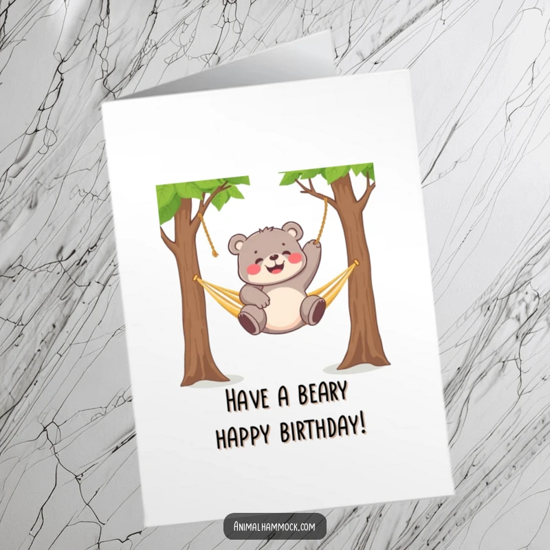 Funny Free Printable Birthday Card: Chubby bear cub happily dangling upside down from a hammock.