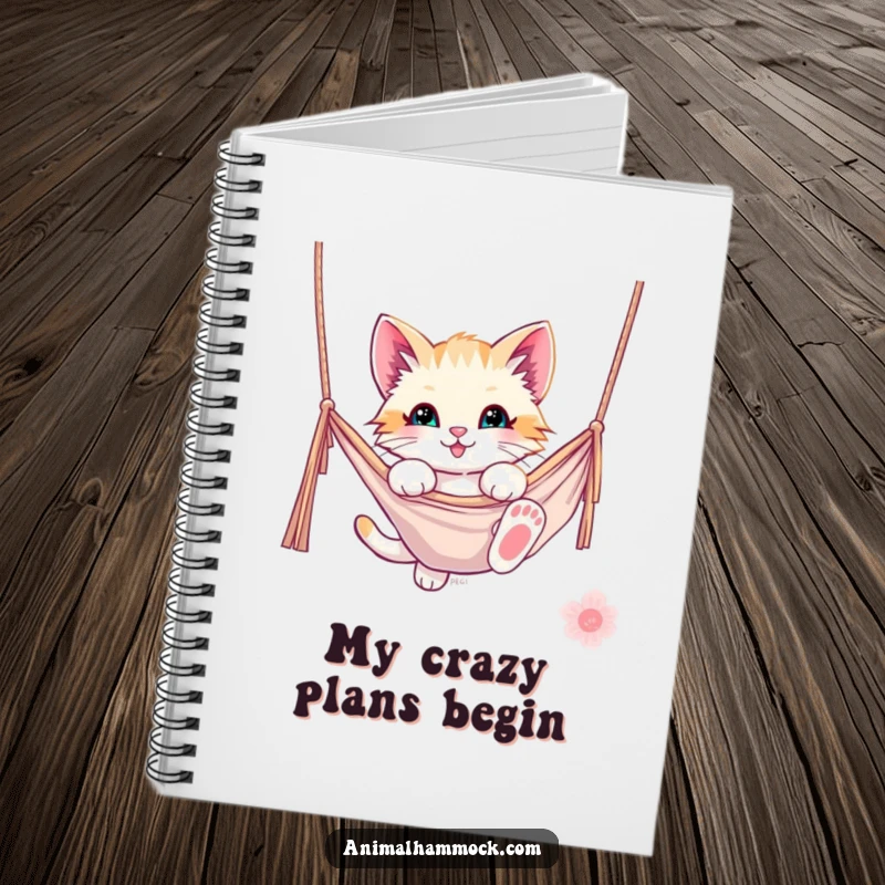 Funny kitten notebook featuring a playful kitten dangling from a hammock, perfect for jotting down notes with a smile. A funny and practical item.