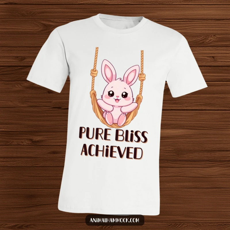 Funny t-shirt depicting a fluffy pink bunny with wide eyes, blissfully swinging high on a rope hammock, radiating pure joy.